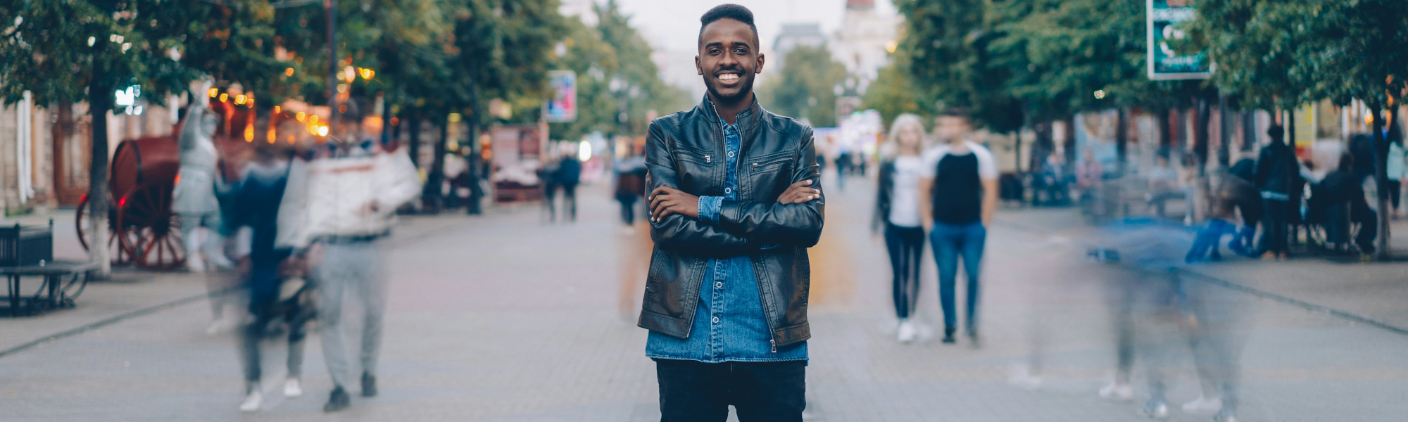A young man standing in the street. Photo Credit: Vitaly Gariev