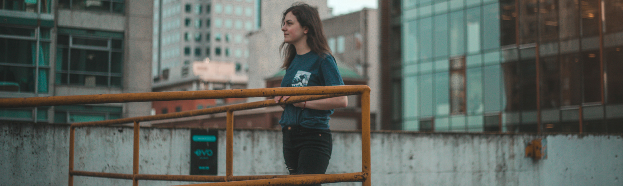 A woman standing against an orange railing - Photo credit: John Lord Vicente
