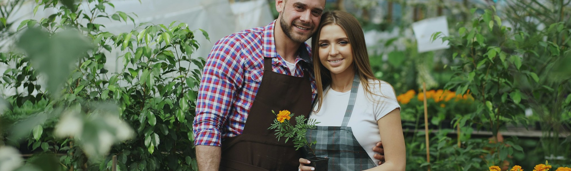 A young couple taking a selfie with flowers. Photo Credit: Vitaly Gariev